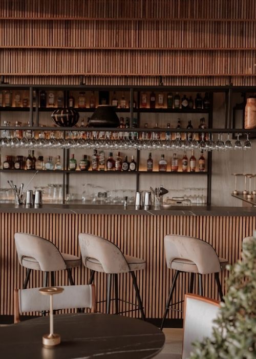 The bar is made of wood, showing an elegant and cozy design
