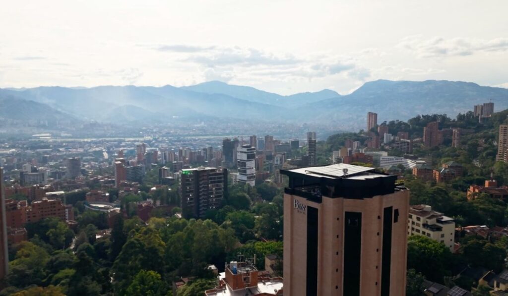 Image of the city from above, with buildings and cityscapes visible on the horizon.