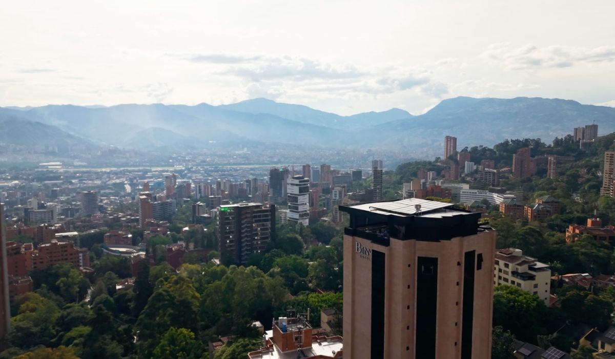 Image of the city from above, with buildings and cityscapes visible on the horizon.