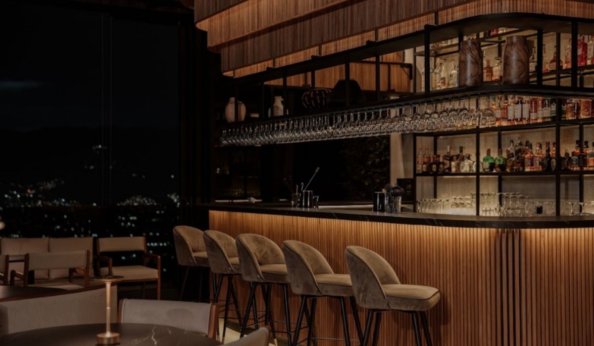 night view of the etro rooftop and the city, illuminated by bright lights and a cozy atmosphere.