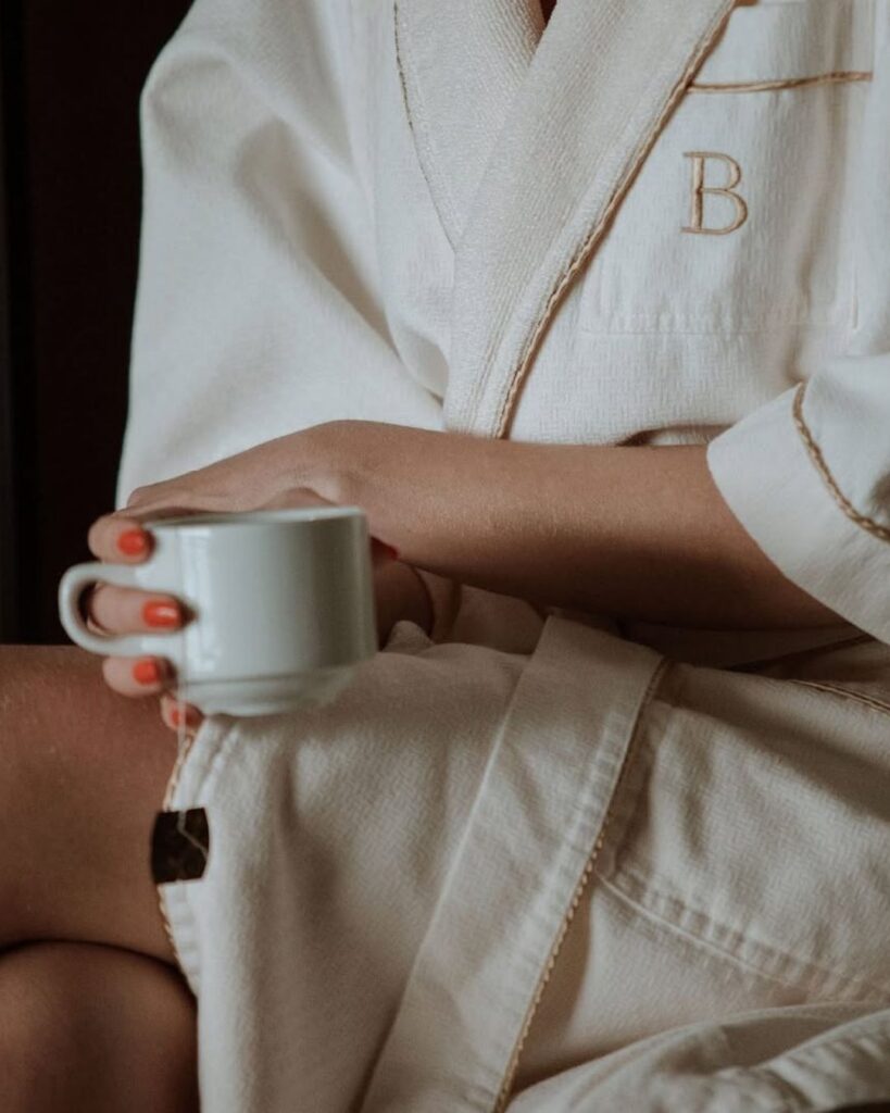 Woman in a bathrobe holding a cup of coffee at a luxury spa in Medellín