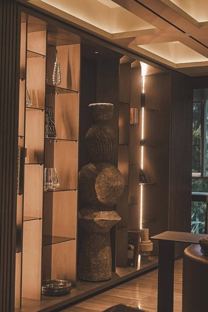 An elegant room with a large stone sculpture on the wall, reflecting the luxury of boutique hotels