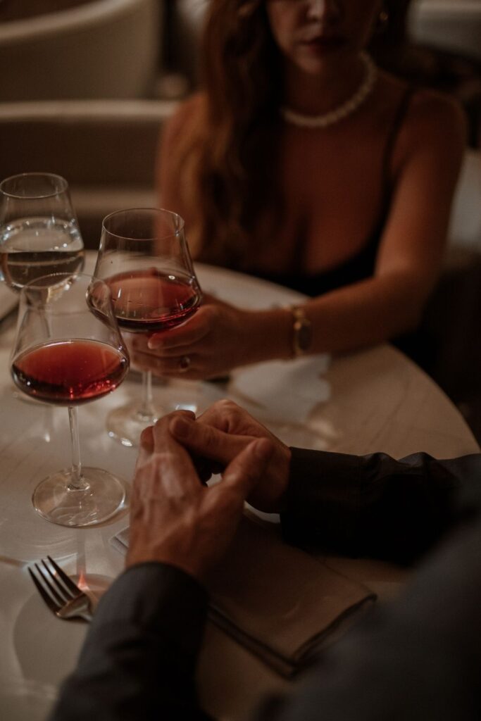 Couple holding hands at a restaurant table, enjoying a private experience at La Makha