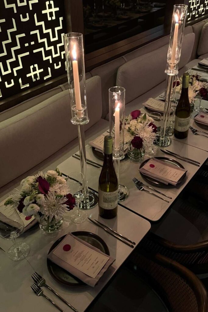 Elegantly decorated table with wine glasses and candles, ideal for a luxurious wedding menu