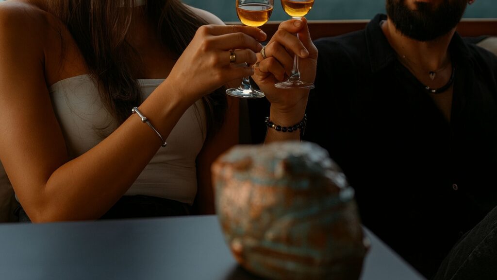 man and woman joyfully toasting with wine glasses, celebrating experiences at Etro.