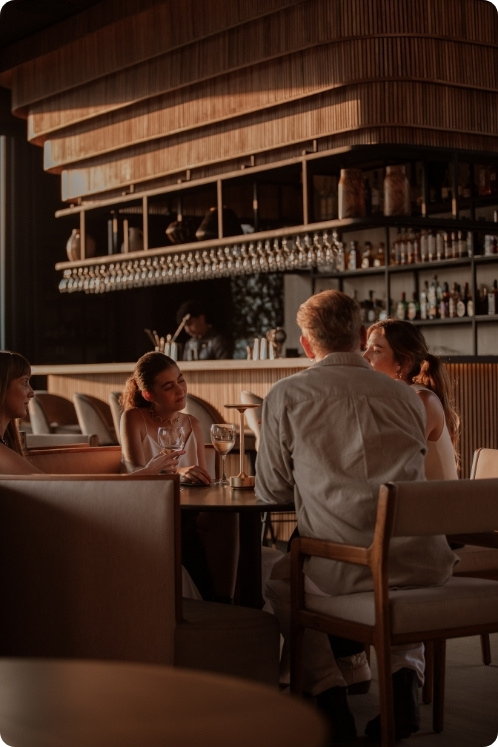 Personas sentadas en una mesa en un restaurante con vistas a los techos de Medellín.