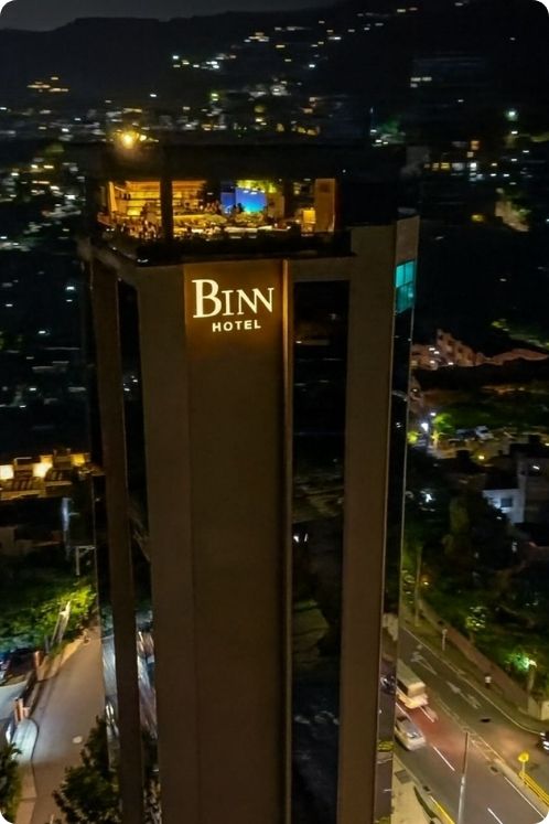 BINN hotel iluminado por la noche, con luces brillantes en los techos exitosos.