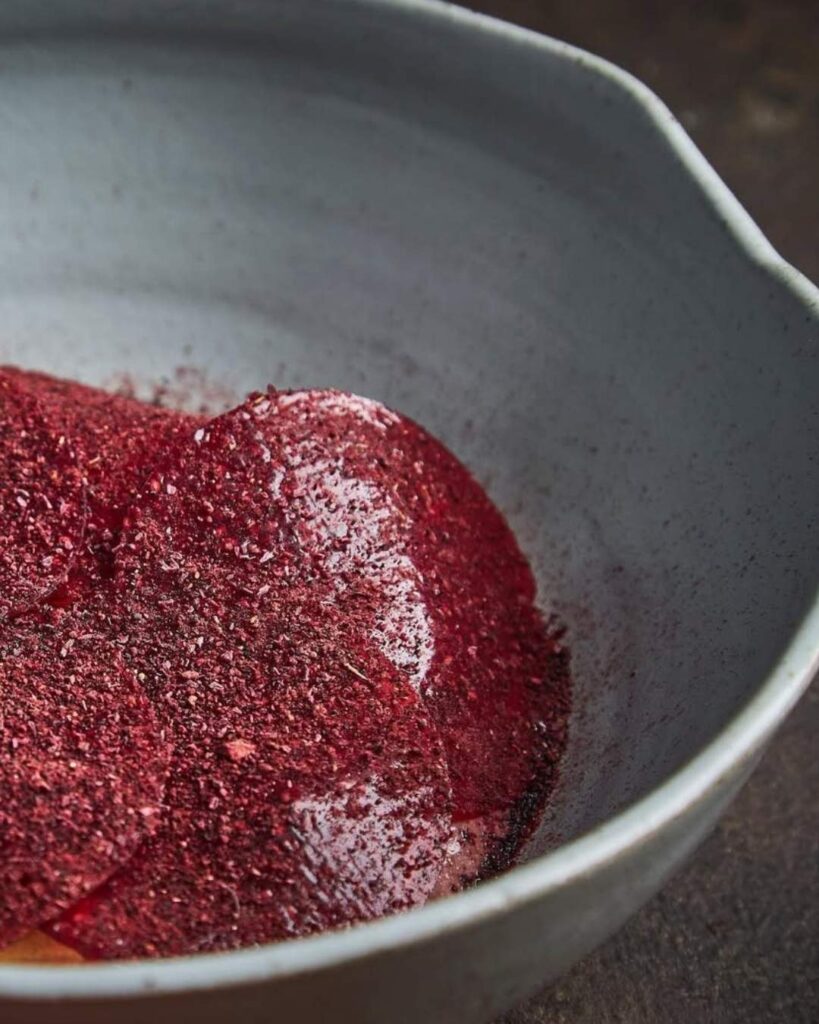 Bowl of red powder on a table