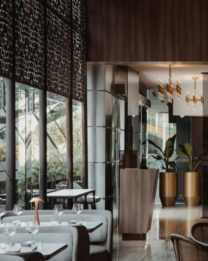 View of the interior of a contemporary restaurant with wooden walls.