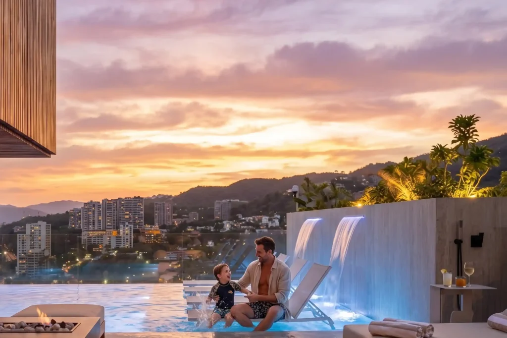 Padre e hijo en la piscina infinity de BINN Hotel con vista panorámica de Medellín al atardecer.