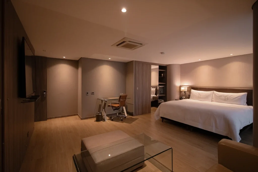 Junior Suite Deluxe at BINN Hotel with king bed, desk and hardwood floors.