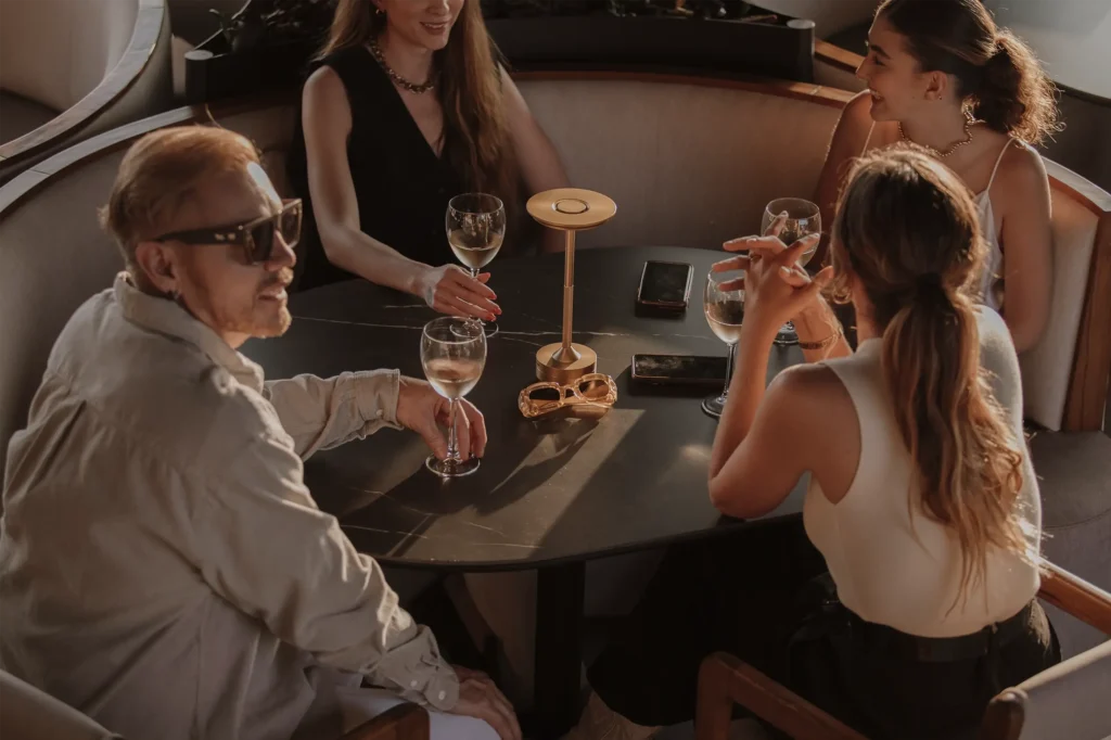 Group of people sharing wine glasses at BINN Hotel lounge during a holiday weekend
