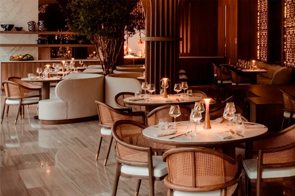 La Makha dining room atmosphere with warm lighting for booking in Medellín