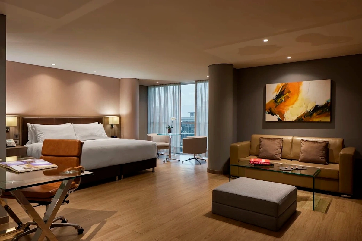Junior Suite Deluxe City View at Binn Hotel with sitting area and skyline view