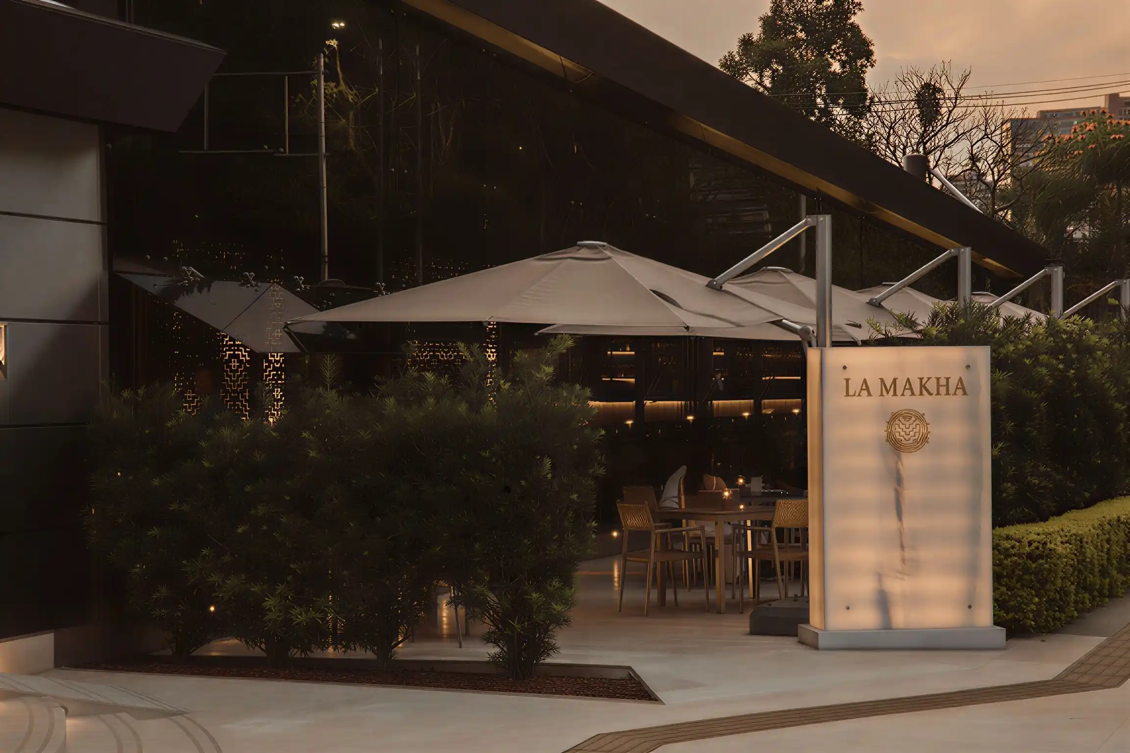 Illuminated entrance and terrace of La Makha Restaurant for luxury executive dining in El Poblado.