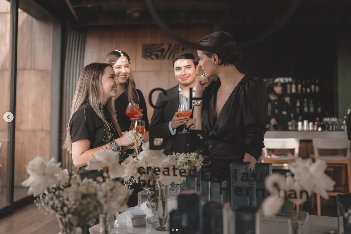 Guests socializing during a corporate brand launch event at Etro Rooftop Medellín.