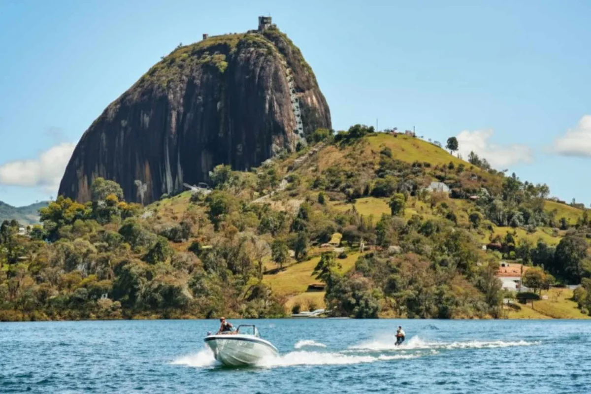 Boat sailing in front of the Piedra del Penol, an ideal route across east Antioquia from Medellin.
