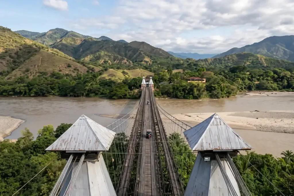 Wooden suspension bridge Puente de Occidente across the Cauca River and hills in Santa Fe de Antioquia.