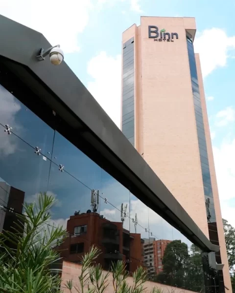 Binn Hotel facade in Medellín under clear skies during the dry season