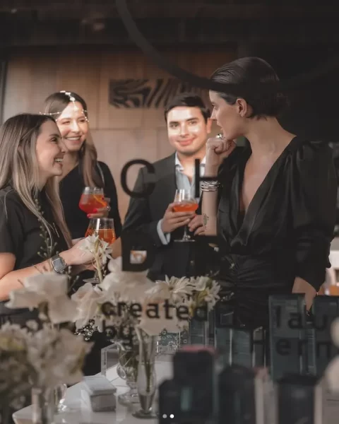 Guests socializing during a corporate brand launch event at Etro Rooftop Medellín.