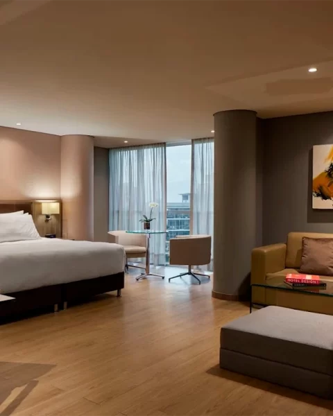 Junior Suite Deluxe City View at Binn Hotel with sitting area and skyline view